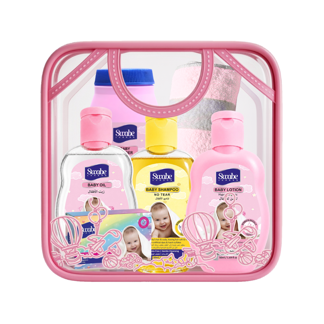 A clear plastic baby gift set bag with a pink handle and pink border, containing three bottles of Strube baby products (Baby Oil, Baby Shampoo, Baby Lotion baby powder ) and a small soft towel with a white background.