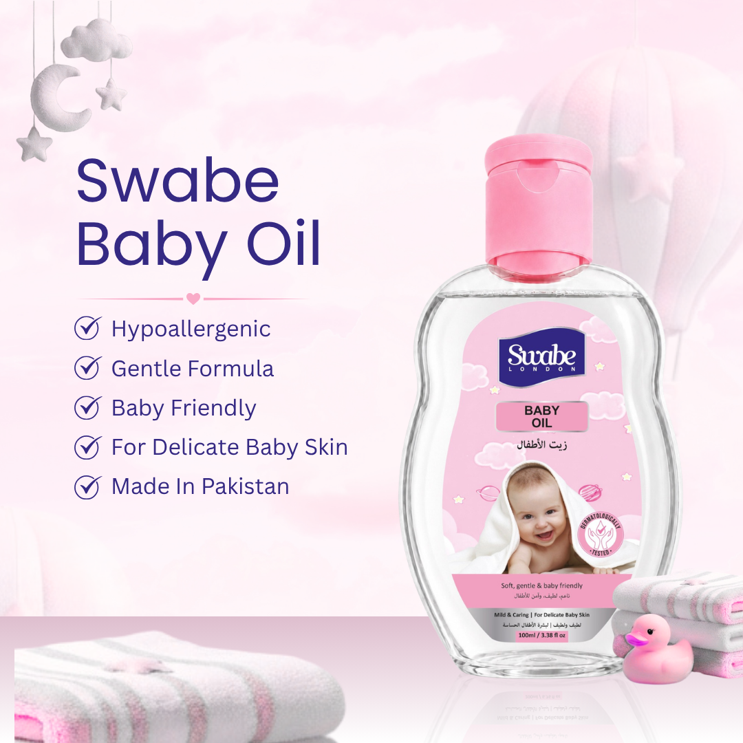 A bottle of Swabe Baby Oil with a pink cap and pink label, shown on a soft pink background with promotional text, folded towels, and small bath accessories. The Swabe brand name is visible on the bottle.